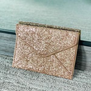 Gold sequin clutch with gold chain.